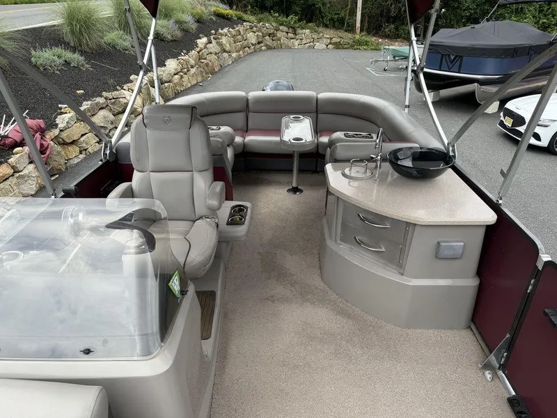 Slide: The Image of Interior of a 2015 Premier 250 Solaris pontoon boat with seating and helm. - 16