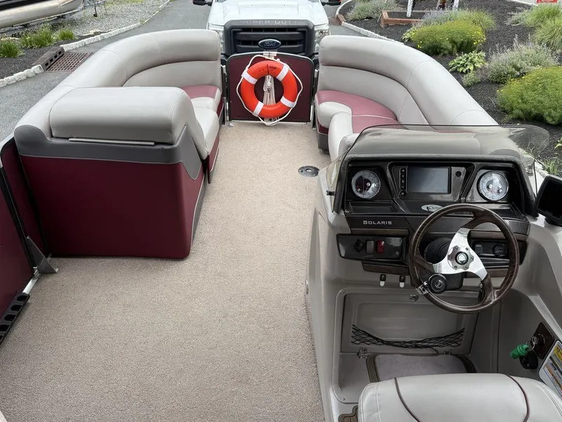 Slide: The Image of Interior of a 2015 Premier 250 Solaris pontoon boat with seating and steering console. - 17