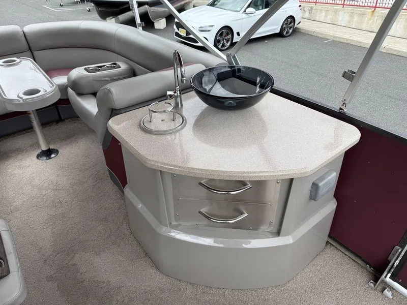 Slide: The Image of Interior of a 2015 Premier 250 Solaris boat with seating and a countertop. - 19