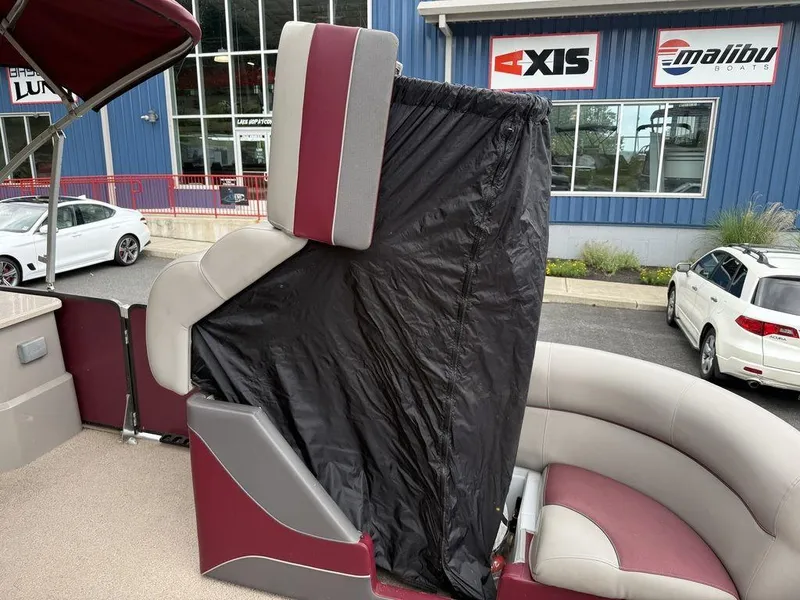 Slide: The Image of 2015 Premier 250 Solaris boat interior with maroon and gray seating, near dealership. - 20
