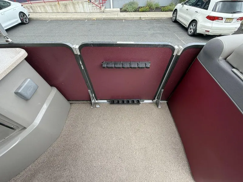 Slide: The Image of Interior of a 2015 Premier 250 Solaris boat with maroon paneling and carpeted floor. - 21