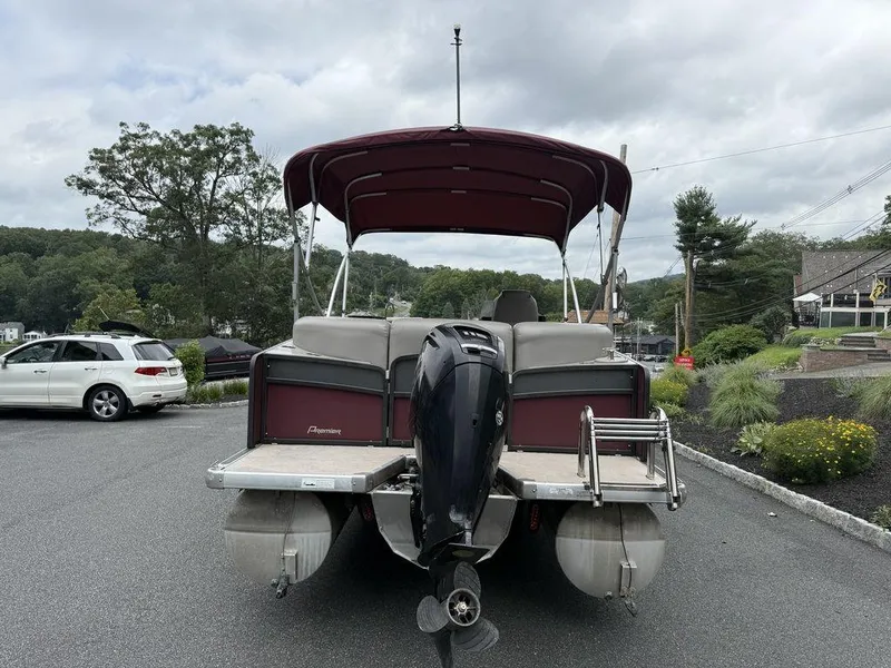 Slide: The Image of 2015 Premier 250 Solaris pontoon boat with outboard motor in a parking lot. - 4