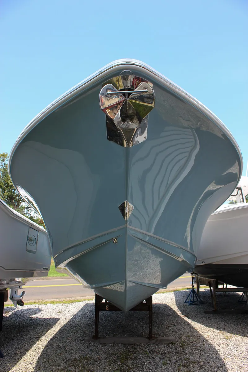 Slide: The Image of 2026 Sea Hunt Ultra 265 SE boat, front view, displayed outdoors on gravel. - 15
