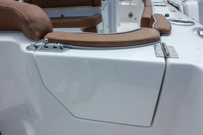Slide: The Image of 2026 Sea Hunt Ultra 265 SE boat seating with brown cushions and white panel. - 16