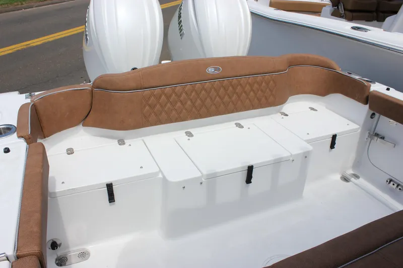Slide: The Image of 2026 Sea Hunt Ultra 265 SE boat interior with tan seating and storage compartments. - 19