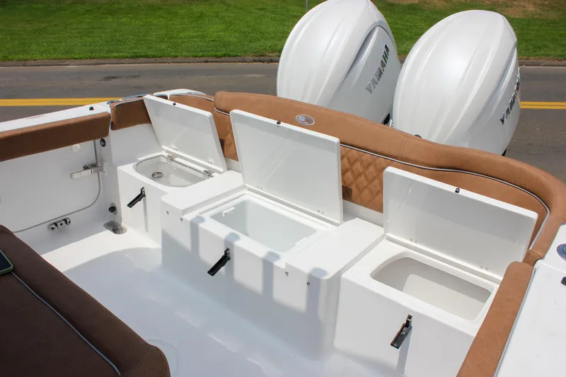 Slide: The Image of 2026 Sea Hunt Ultra 265 SE boat interior with open storage compartments and twin Yamaha engines. - 22