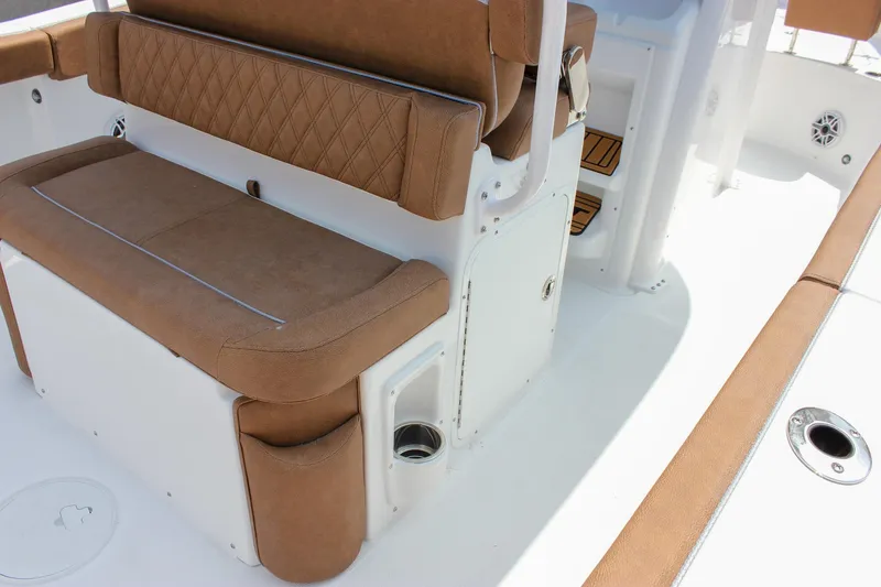 Slide: The Image of 2026 Sea Hunt Ultra 265 SE boat interior with brown cushioned seating and storage compartments. - 26