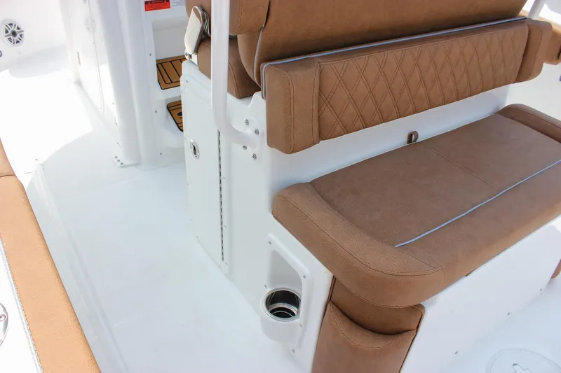 Slide: The Image of 2026 Sea Hunt Ultra 265 SE boat interior with brown cushioned seating. - 27