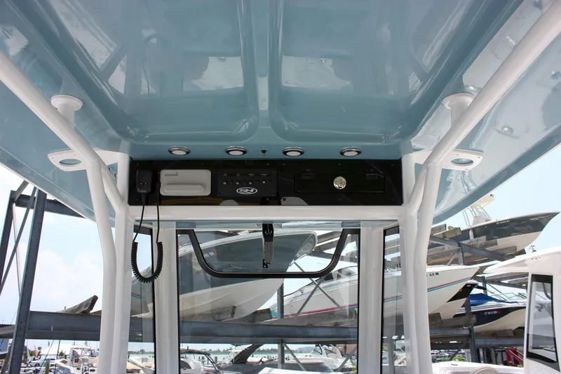 Slide: The Image of 2026 Sea Hunt Ultra 265 SE boat interior with electronics and storage compartments. - 28