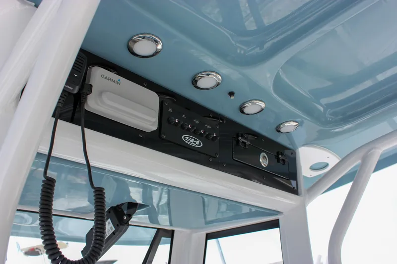 Slide: The Image of 2026 Sea Hunt Ultra 265 SE boat console with Garmin electronics and overhead lighting. - 3