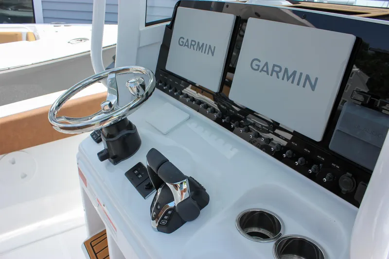 Slide: The Image of 2026 Sea Hunt Ultra 265 SE helm with dual Garmin displays and modern controls. - 31