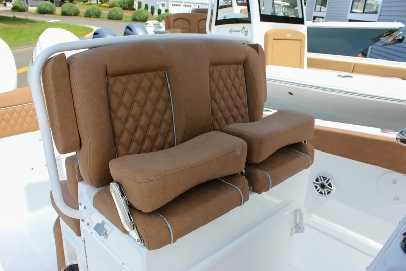 Slide: The Image of Luxurious seating on 2026 Sea Hunt Ultra 265 SE boat, featuring brown cushioned seats. - 32