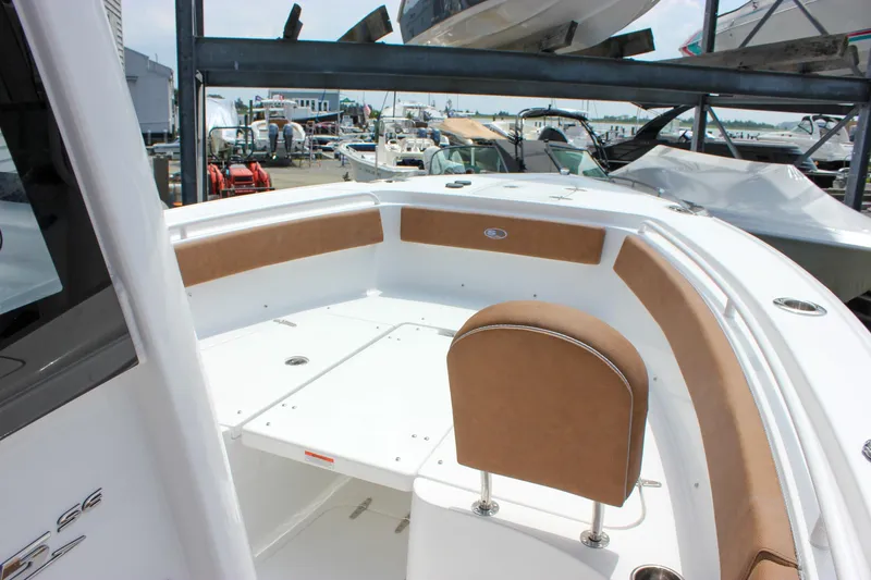 Slide: The Image of 2026 Sea Hunt Ultra 265 SE boat interior with tan seating, docked in marina. - 33