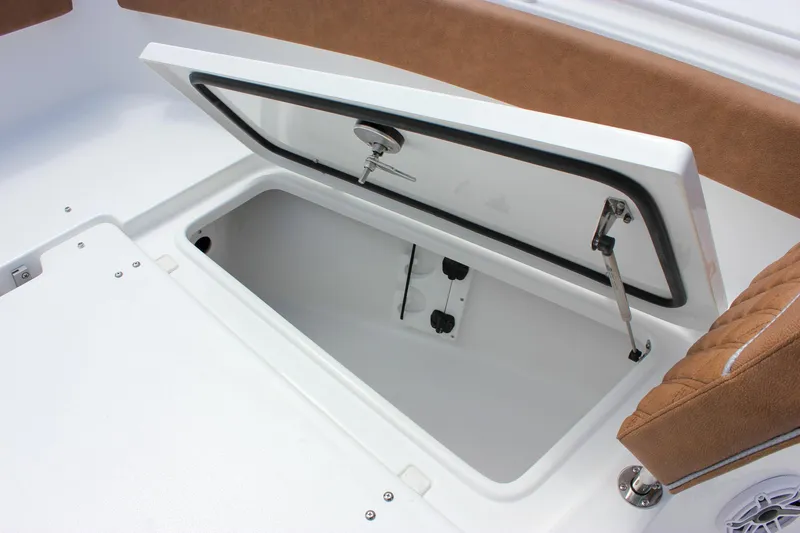 Slide: The Image of 2026 Sea Hunt Ultra 265 SE boat storage compartment with open hatch and cushioned seating. - 35