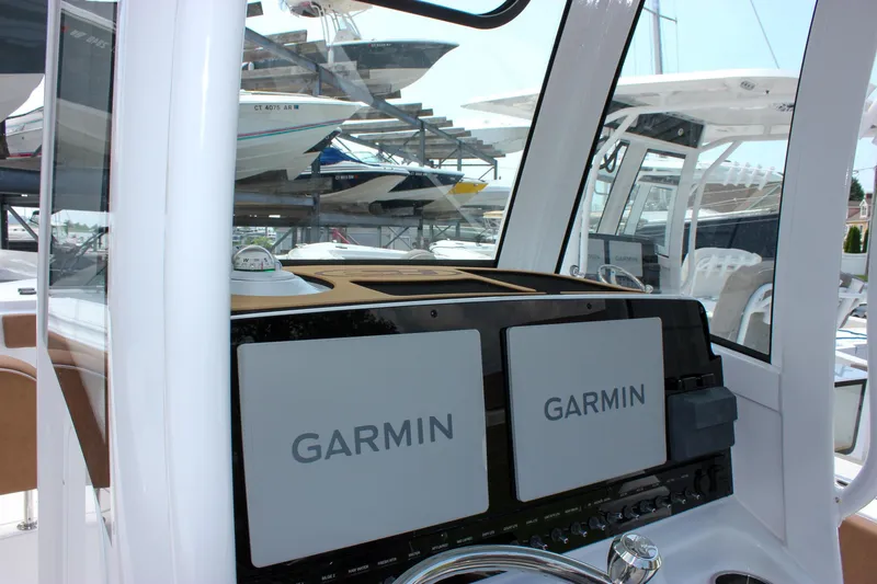 Slide: The Image of 2026 Sea Hunt Ultra 265 SE boat dashboard with dual Garmin displays. - 37