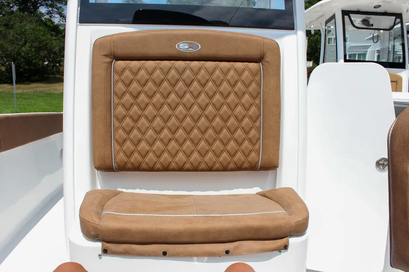 Slide: The Image of 2026 Sea Hunt Ultra 265 SE boat seat with diamond-stitched brown upholstery. - 39