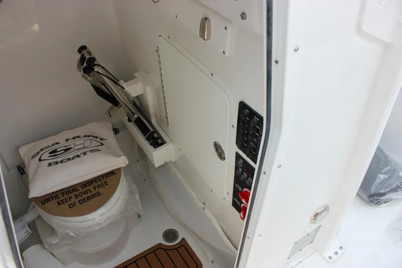 Slide: The Image of Interior of 2026 Sea Hunt Ultra 265 SE boat, featuring storage and control panel. - 41