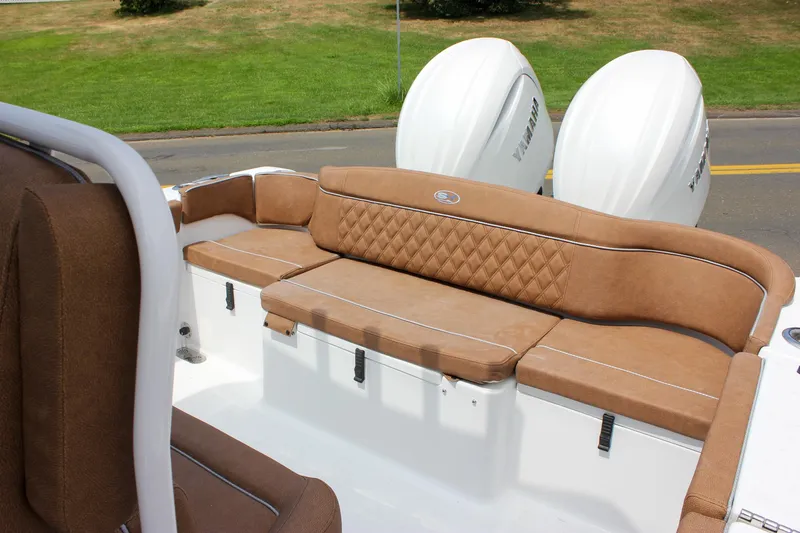 Slide: The Image of 2026 Sea Hunt Ultra 265 SE boat with brown cushioned seating and dual Yamaha engines. - 5