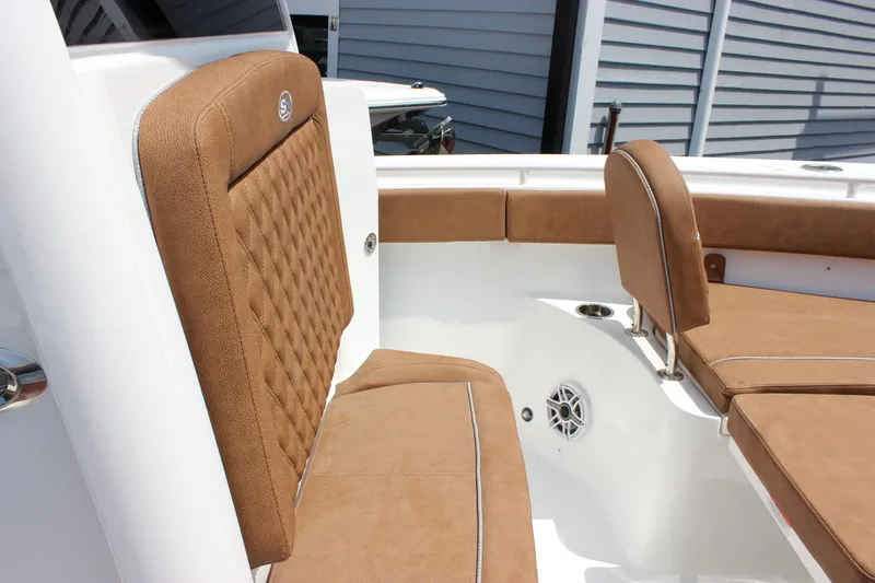 Slide: The Image of 2026 Sea Hunt Ultra 265 SE boat with tan cushioned seating and white interior. - 6