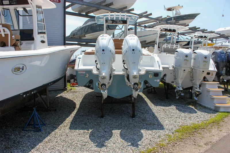 Slide: The Image of 2026 Sea Hunt Ultra 265 SE boat with dual engines displayed in a marina. - 8