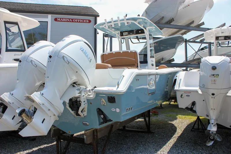 Slide: The Image of 2026 Sea Hunt Ultra 265 SE boat with dual Yamaha engines at marina. - 9