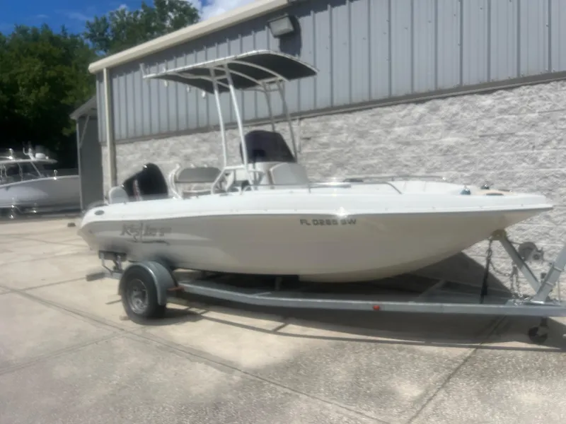 Slide: The Image of 2021 Key Largo 1801 CC boat on trailer, parked outside a building. - 1