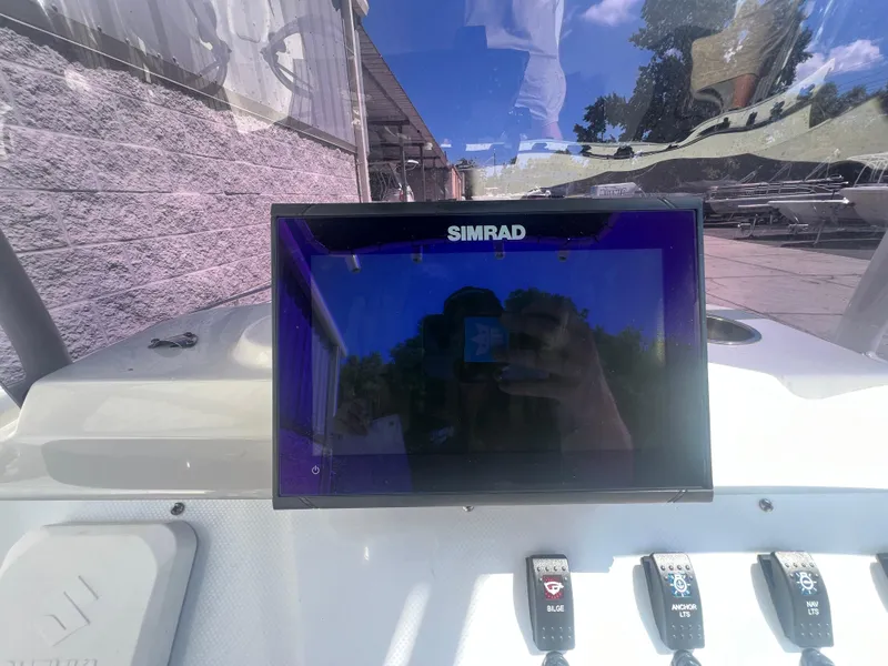 Slide: The Image of Simrad display on 2021 Key Largo 1801 CC boat dashboard with control switches. - 10