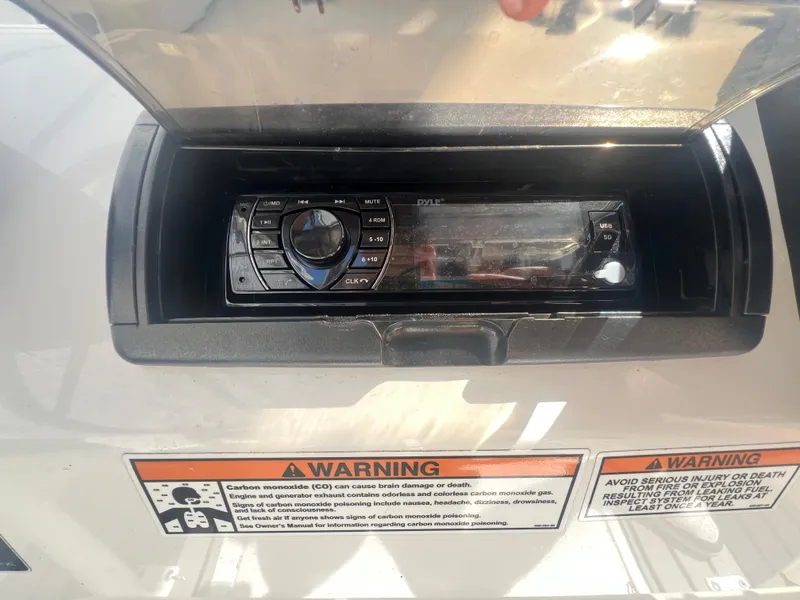 Slide: The Image of Boat stereo system with warning labels on a 2021 Key Largo 1801 CC. - 12