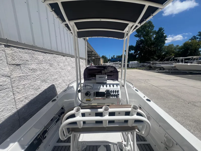 Slide: The Image of 2021 Key Largo 1801 CC boat interior with steering console and canopy. - 6