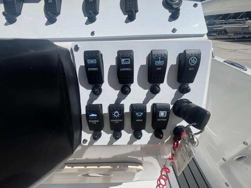 Slide: The Image of Control panel of a 2021 Key Largo 1801 CC boat with various switches. - 8