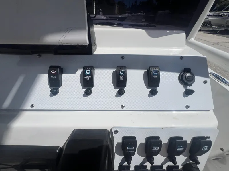 Slide: The Image of Control panel of a 2021 Key Largo 1801 CC boat with various switches. - 9