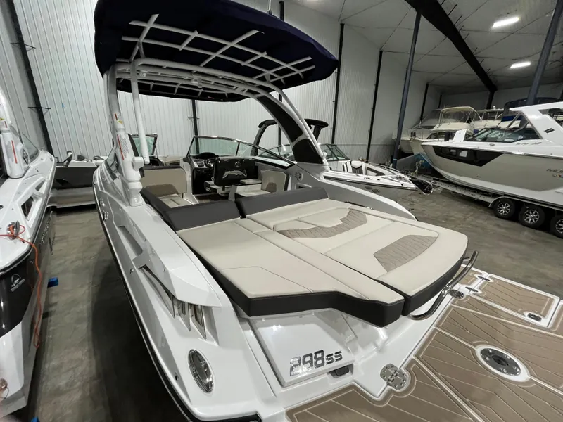 Slide: The Image of 2023 Monterey 298 Super Sport boat in showroom, featuring sleek design and spacious seating. - 4