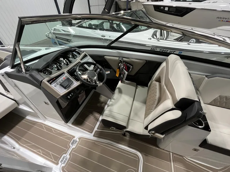 Slide: The Image of 2023 Monterey 298 Super Sport boat interior with sleek dashboard and comfortable seating. - 9