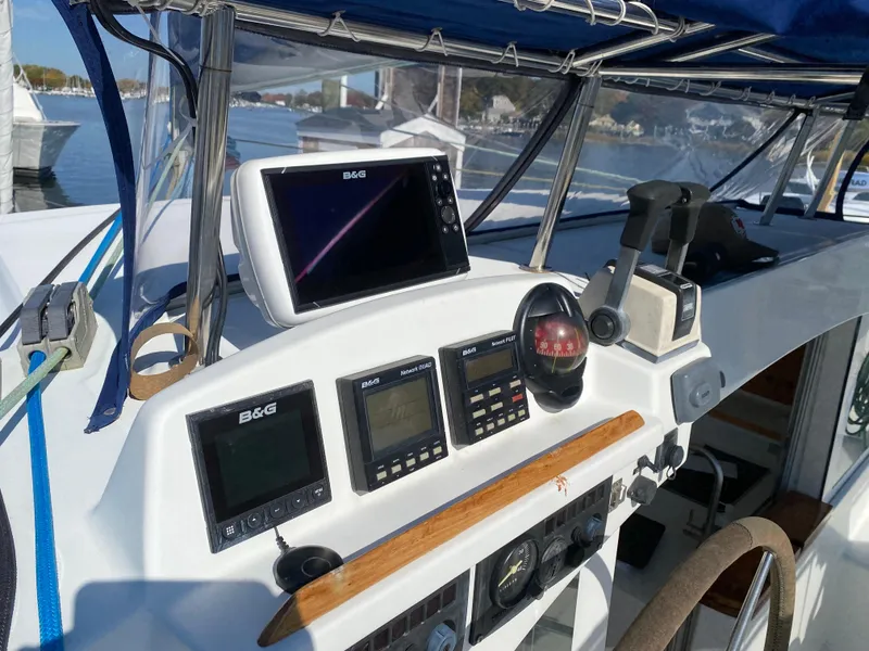 Slide: The Image of Cockpit of 2000 Lagoon 380 catamaran with navigation instruments and controls. - 14