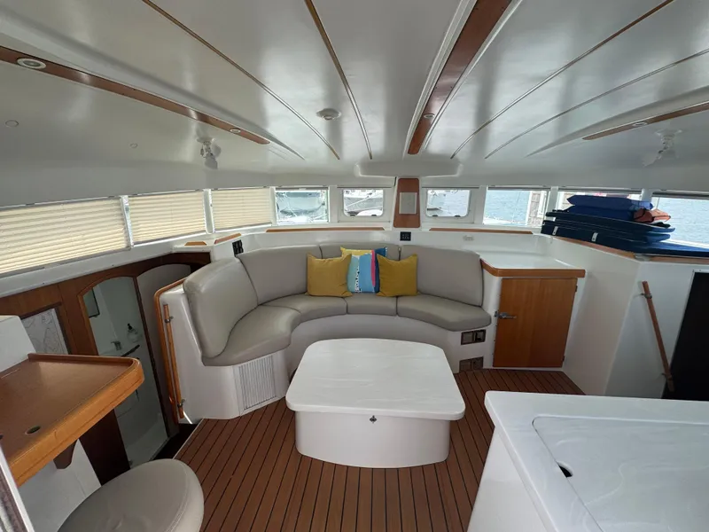 Slide: The Image of Interior of 2000 Lagoon 380 catamaran with modern seating and wooden accents. - 15