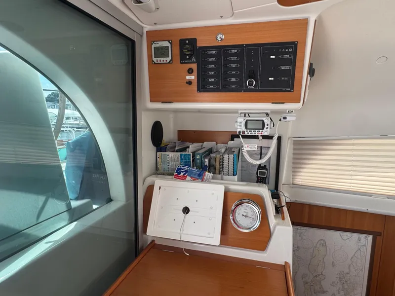 Slide: The Image of Interior of a 2000 Lagoon 380 catamaran with navigation equipment and control panel. - 17