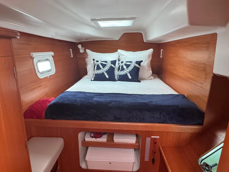 Slide: The Image of Cozy cabin interior of 2000 Lagoon 380 catamaran with nautical-themed bedding. - 21