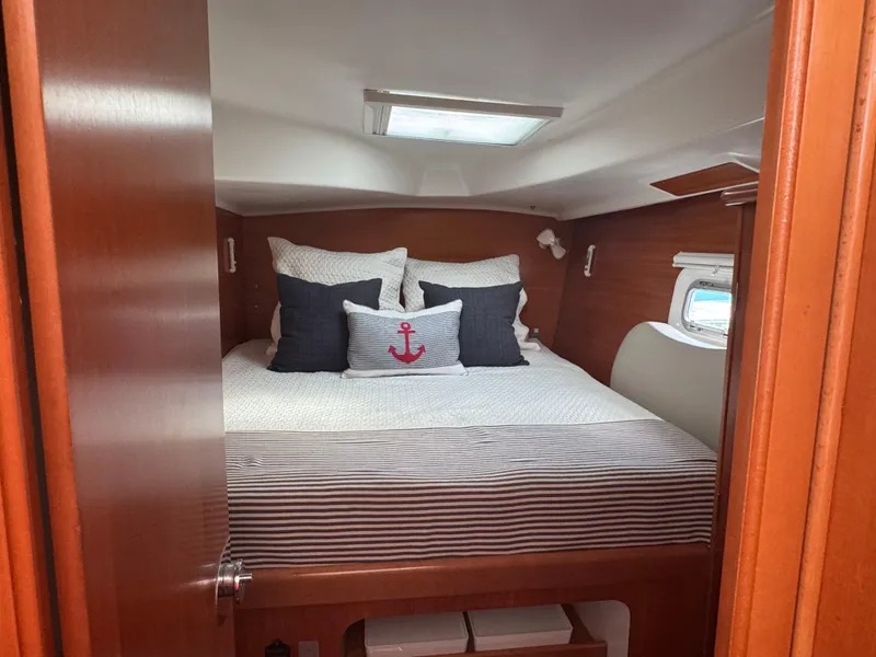 Slide: The Image of Cozy cabin interior of 2000 Lagoon 380 catamaran with nautical-themed bedding. - 25