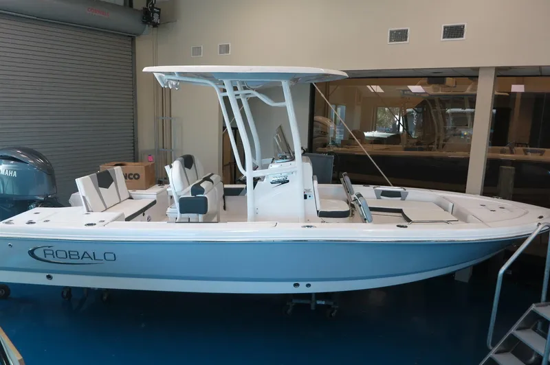 The Image of 2025 Robalo 226 Cayman boat displayed indoors, featuring sleek design and modern amenities. - 1