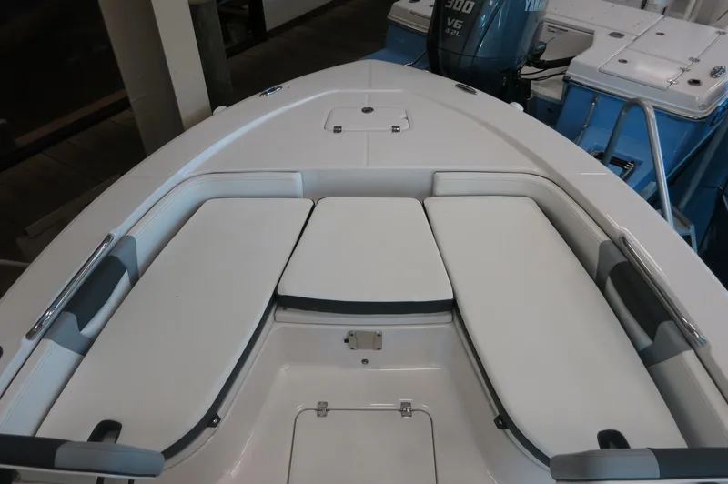 Slide: The Image of 2025 Robalo 226 Cayman boat interior with cushioned seating and storage compartments. - 11