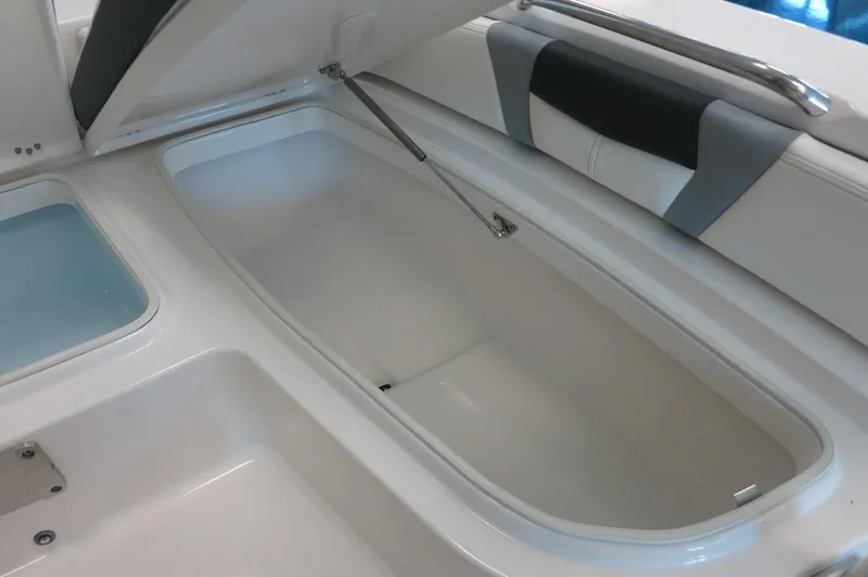 Slide: The Image of Open storage compartment on 2025 Robalo 226 Cayman boat, showcasing spacious interior design. - 14