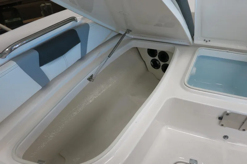 Slide: The Image of 2025 Robalo 226 Cayman boat storage compartments and seating area. - 15