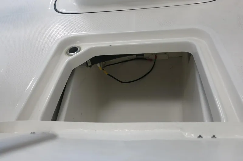 Slide: The Image of Storage compartment of 2025 Robalo 226 Cayman boat, featuring clean white interior. - 16