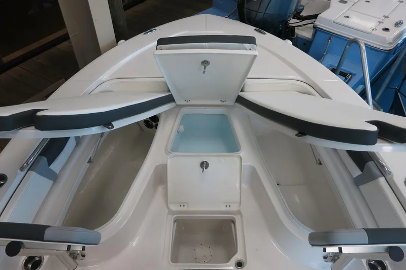 Slide: The Image of 2025 Robalo 226 Cayman boat interior with open storage compartments and seating. - 17