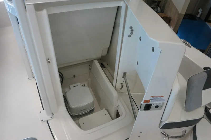 Slide: The Image of 2025 Robalo 226 Cayman boat interior with compact toilet compartment. - 19
