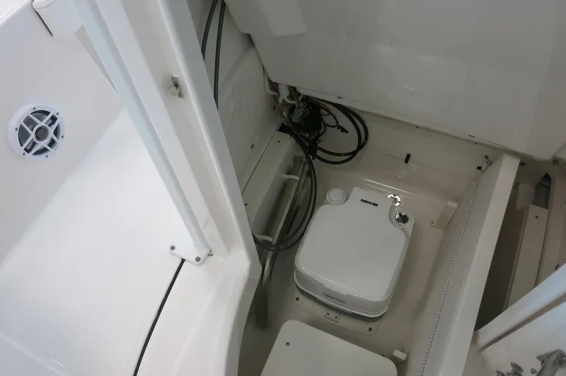 Slide: The Image of 2025 Robalo 226 Cayman boat interior with storage compartment and marine equipment. - 20