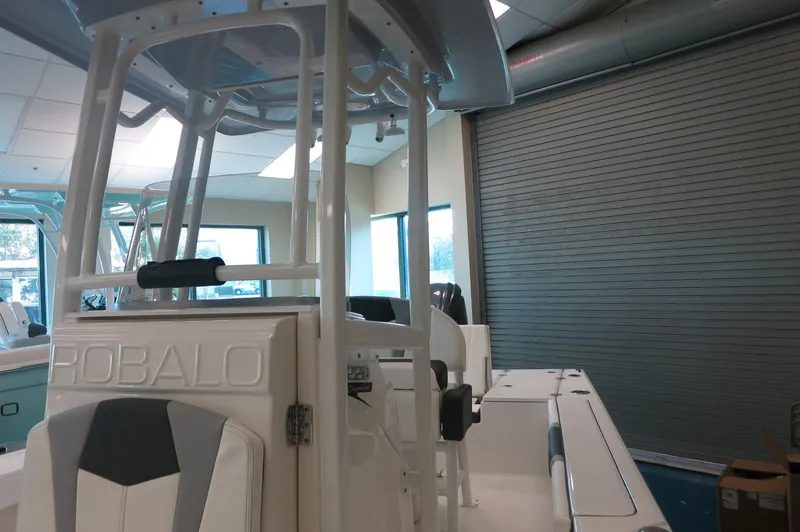 Slide: The Image of 2025 Robalo 226 Cayman boat interior in showroom, featuring sleek design and modern amenities. - 21