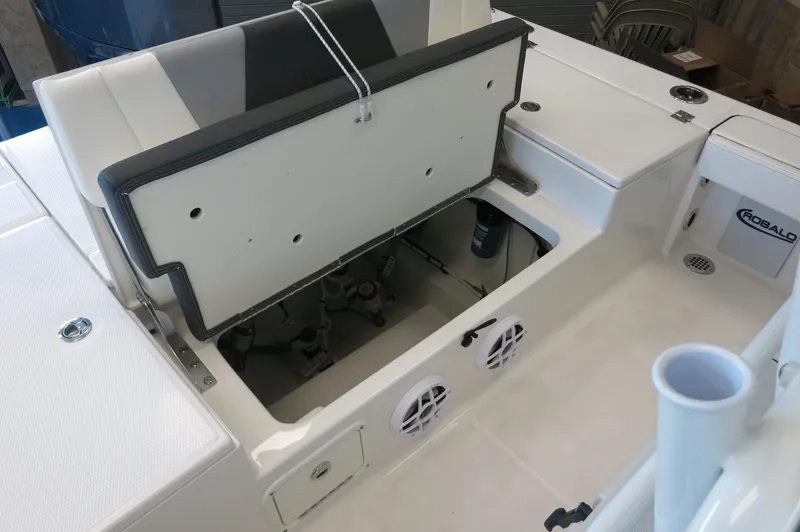 Slide: The Image of 2025 Robalo 226 Cayman boat interior with open storage compartment and seating. - 31