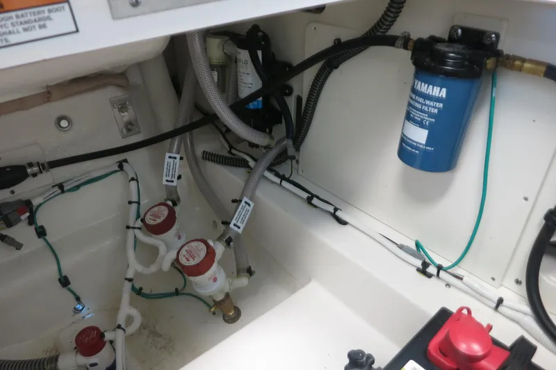 Slide: The Image of 2025 Robalo 226 Cayman boat interior showing fuel filter and wiring. - 33