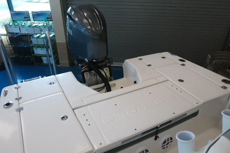 Slide: The Image of 2025 Robalo 226 Cayman boat with outboard motor in showroom. - 35